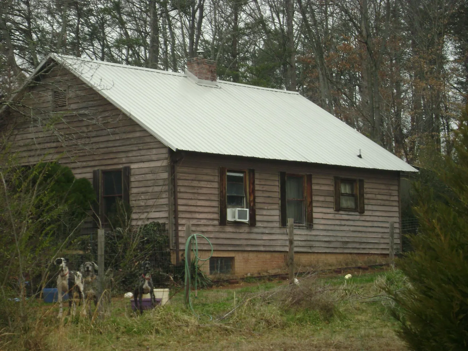 White metal roof on an old wood sided farmhouse, from a Metal Roof Installation job in Waltersburg